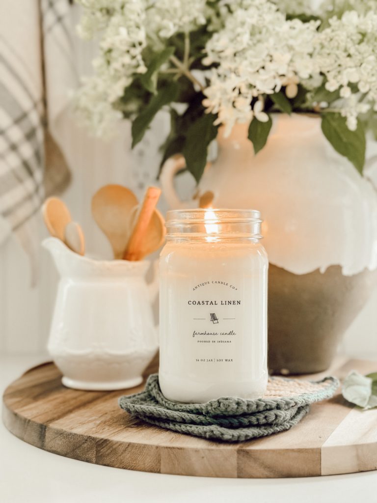 Candle in functional kitchen decor on kitchen countertop.