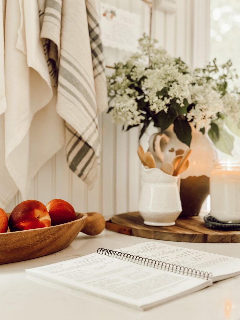 Decorative elements in the kitchen with a cookbook and fresh fruit.