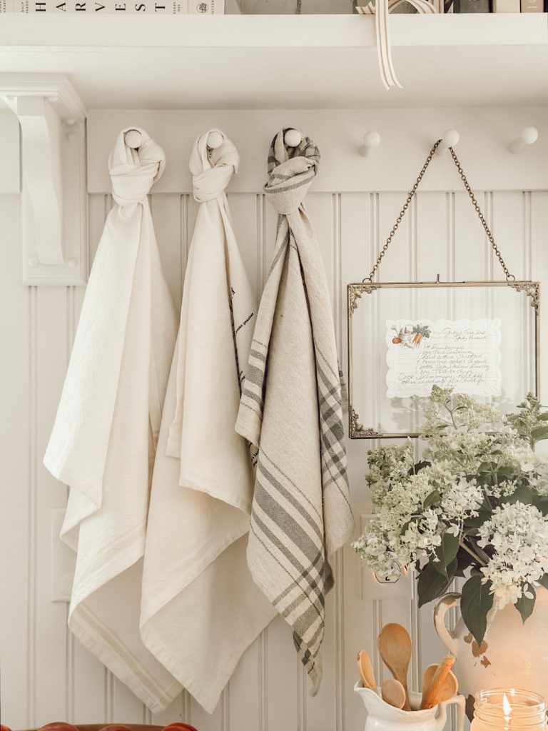 Hanging kitchen towels and a family favorite recipe card in a frame.