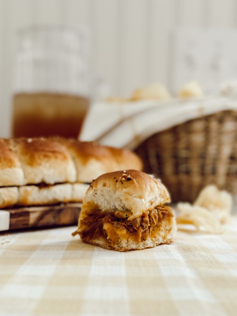 Pork slider recipe with pulled pork, BBQ sauce, and mini rolls.