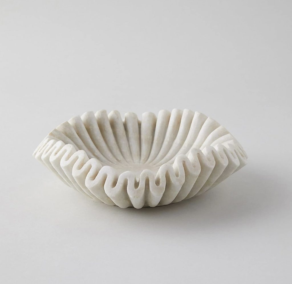 Scalloped marble bowl for unique home decor. 