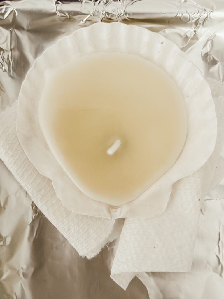 Seashell candle in a scallop shell made with soy wax.
