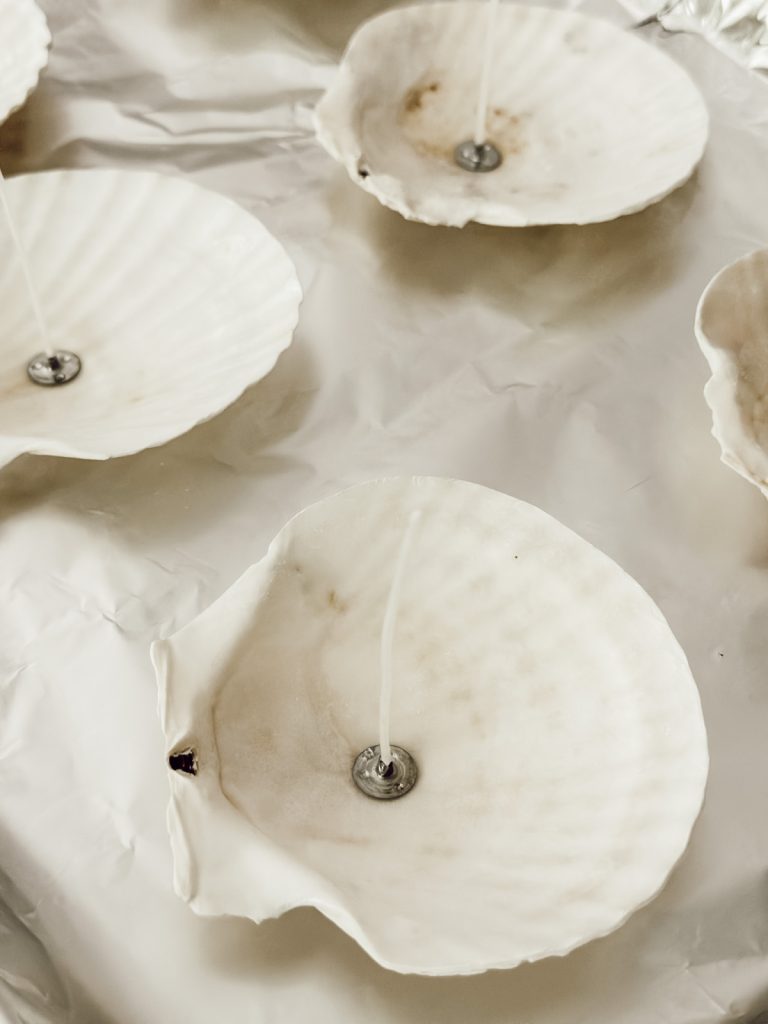 Preparing the shells for the candle wax on a baking sheet.