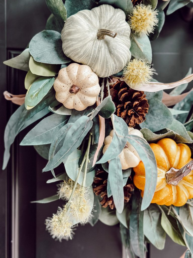 Fall pumpkin & pinecone DIY wreath for fall decor at home.