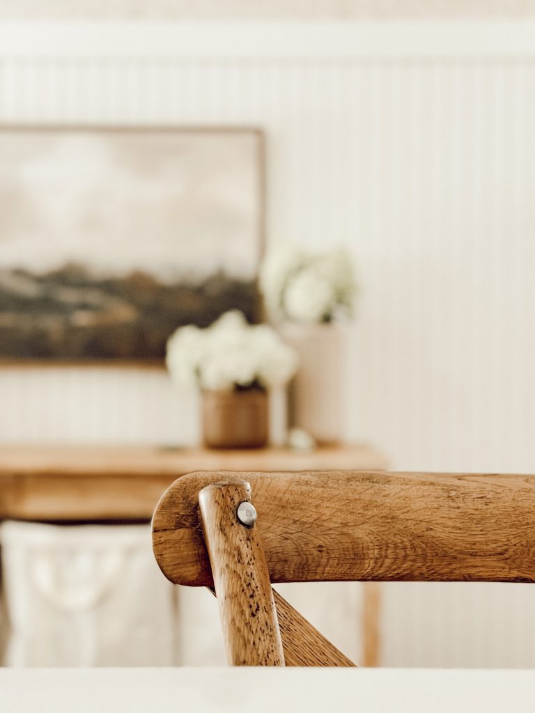 Seasonal fall decor in the kitchen with wooden wall art & vases of flowers.
