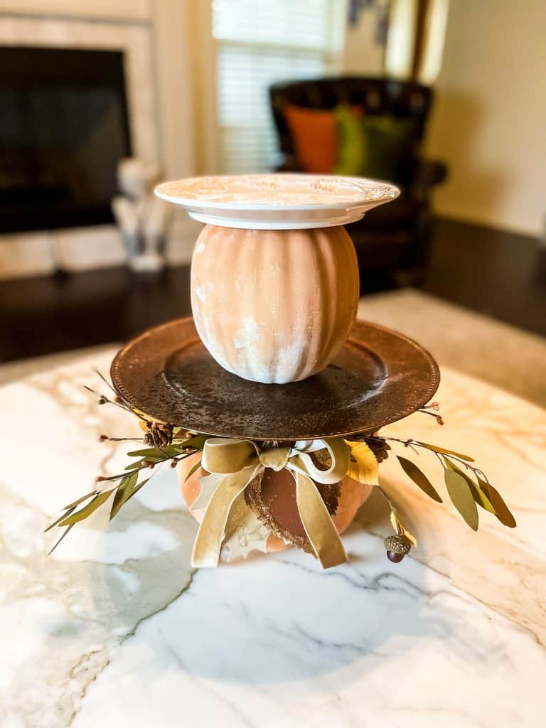 Tiered pumpkin try for fall home decor made with faux pumpkins & plates.