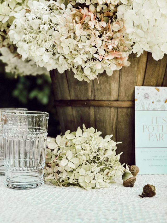 Basket of hydrangeas as the centerpiece of a potluck dinner party.
