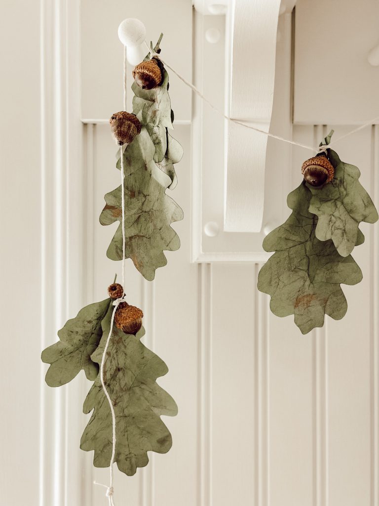 DIY fall garland with acorns and card stock oak leaves.