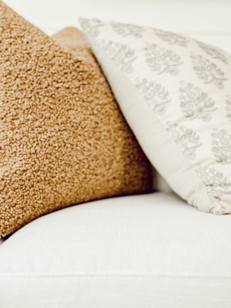 Extra cozy fall throw pillows with warm textures and patterns.