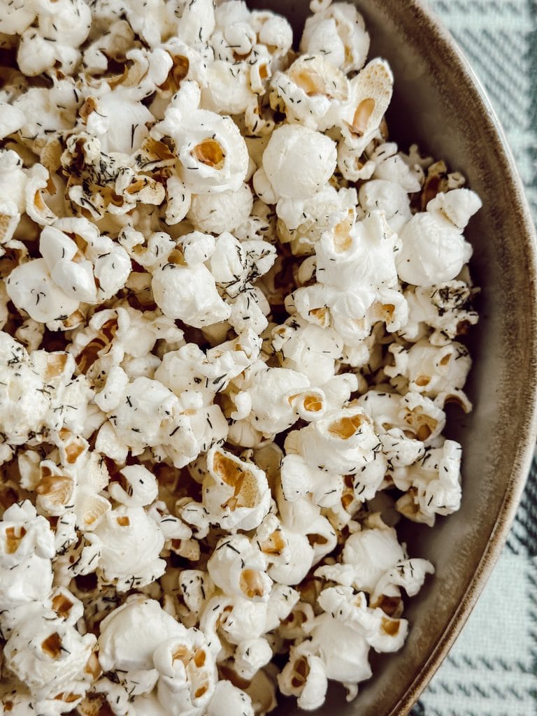 Game day popcorn snack recipe with dill pickle seasoning.