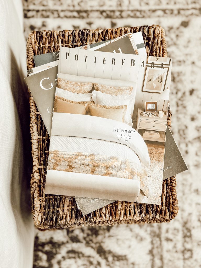 Decor magazines on wicker baskets with a soft rug.