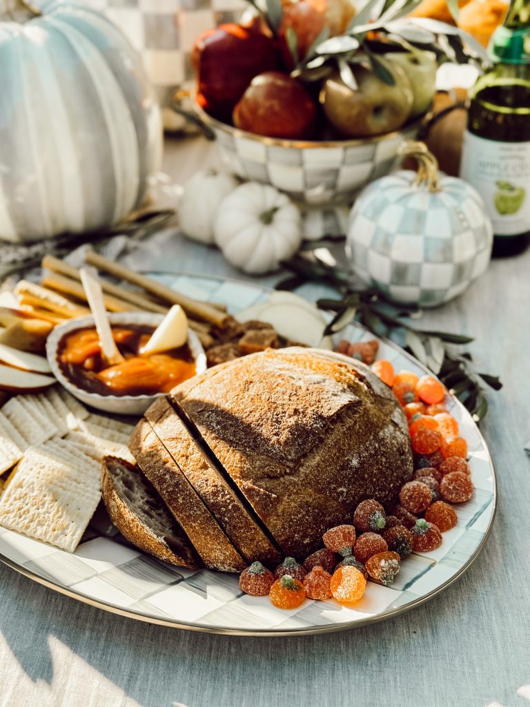 Decorative fruit bowls on a fall tablescape in an outdoor dining space.