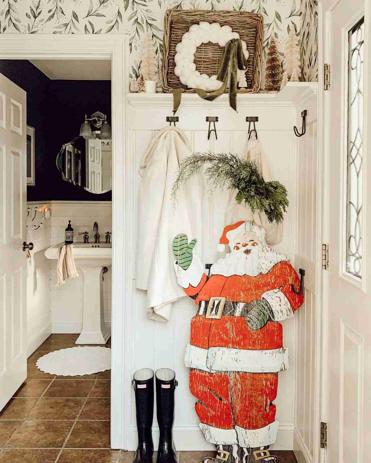 Christmas entryway with vintage Santa for holiday home decor.