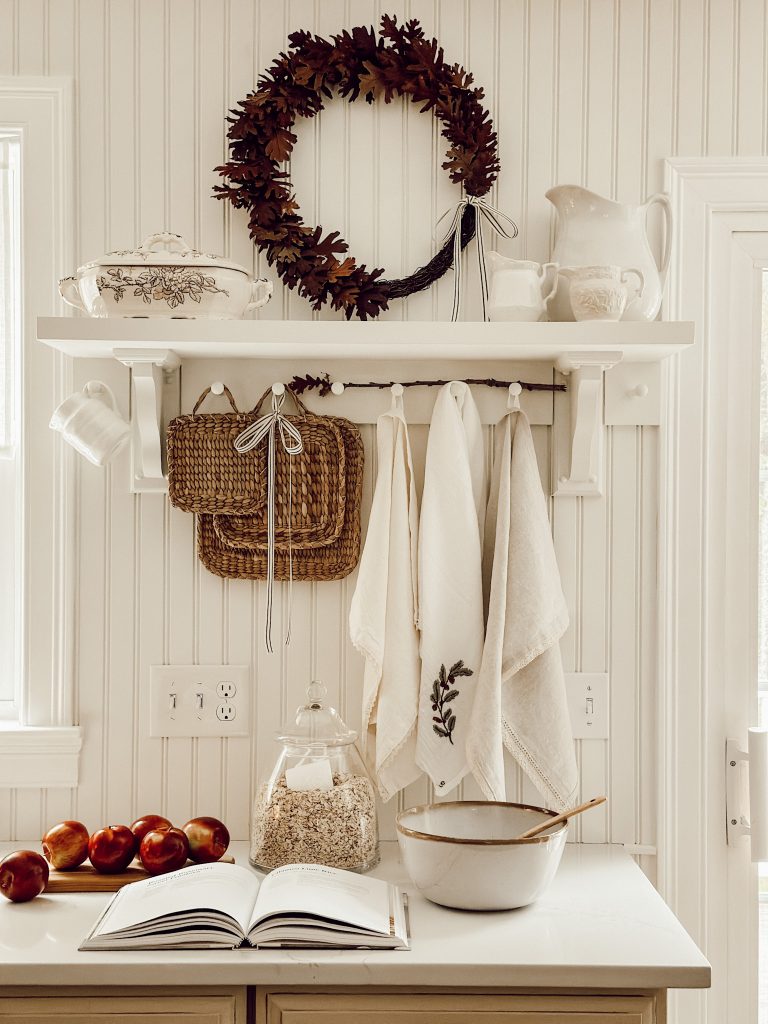 Rustic farmhouse wreath in the kitchen made with oak leaves, grapevine wreath, and hot glue.