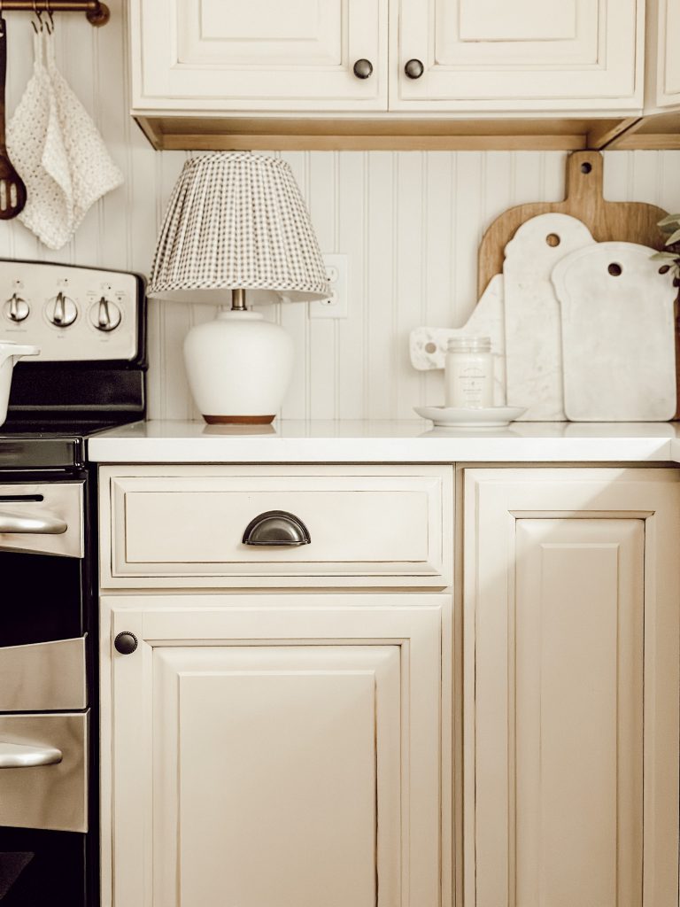 Table lamp on kitchen counter for cozy farmhouse style.