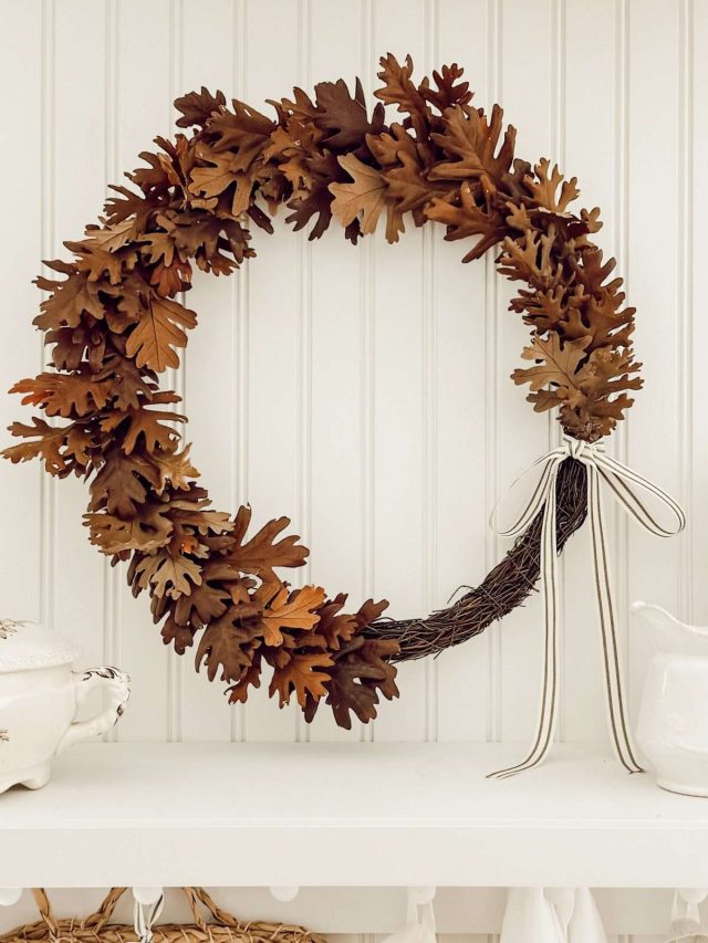 DIY rustic wreath for fall with dried oak leaves, grapevine wreath form, and ribbon.