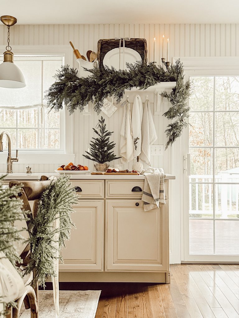 Holiday decorations in a farmhouse kitchen with faux greenery.