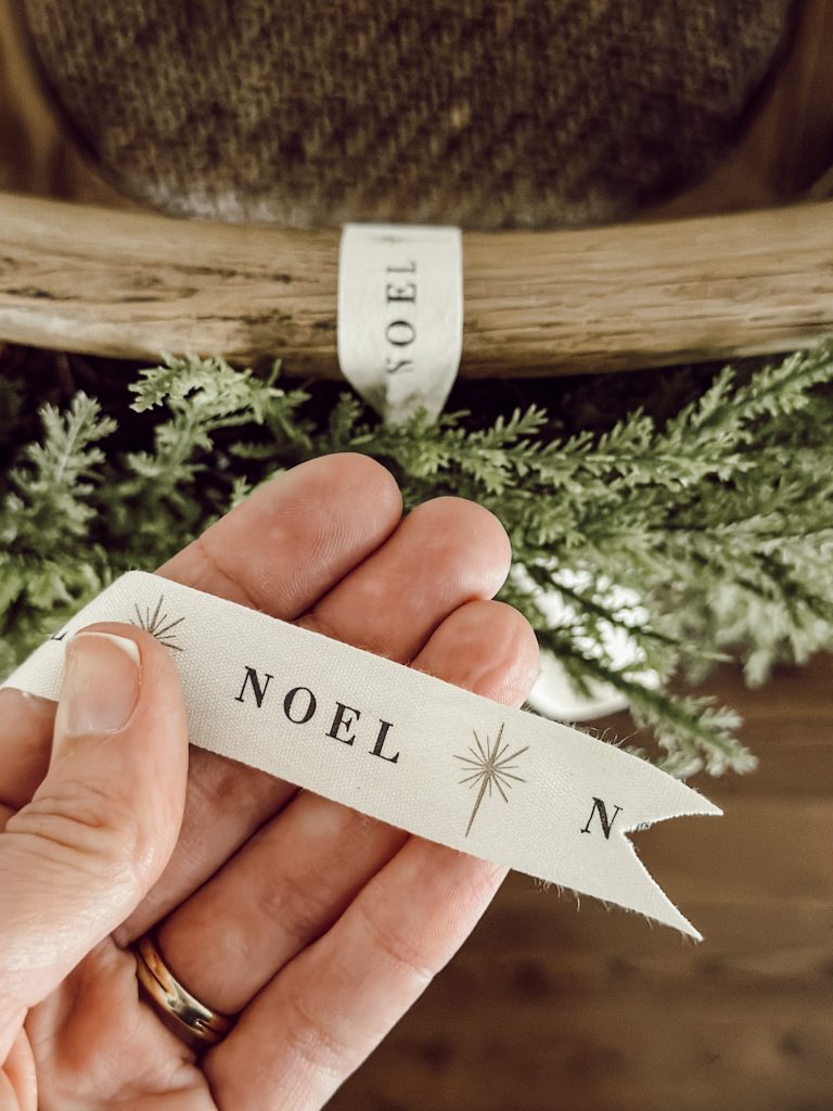 Noel Christmas ribbon to hang wreaths on the back of chairs in the kitchen.