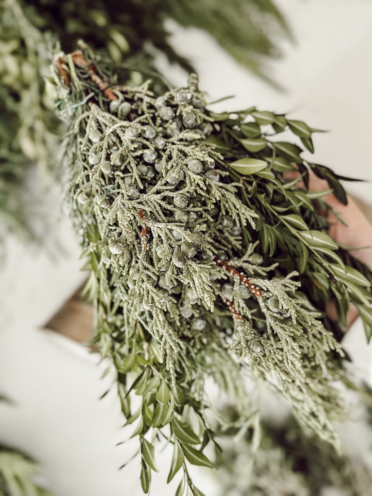 Bundles of fresh greenery for holiday decor in a farmhouse home.