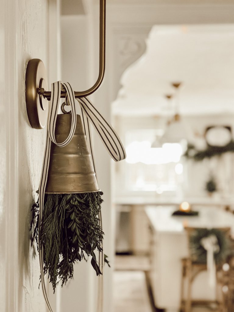 Christmas decorations with ribbon, bells, and fresh greenery.