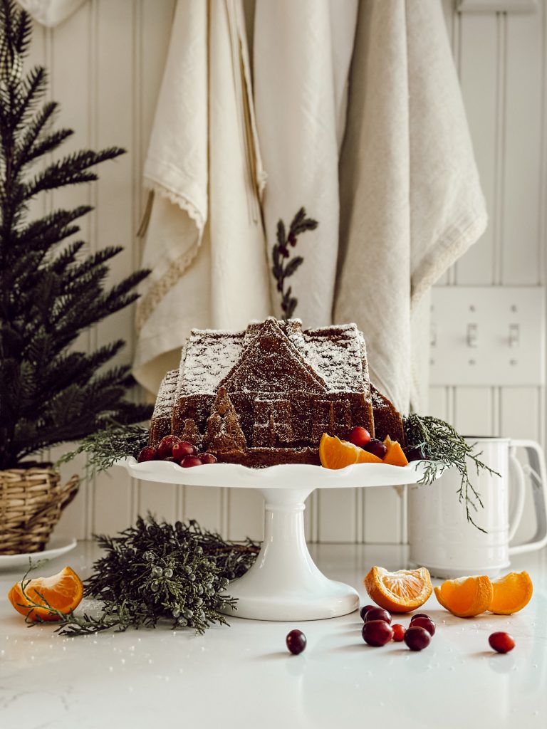 Gingerbread cake mix shaped into a gingerbread house for holiday decor in the kitchen.