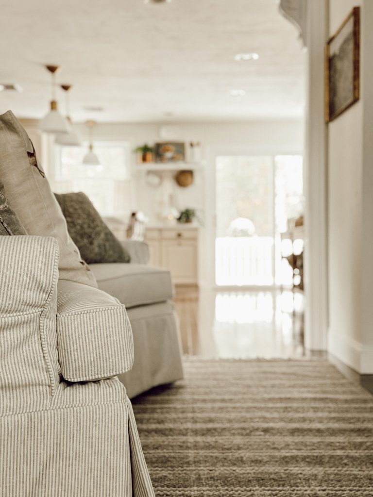 Awkward living room layout with an area rug to anchor the room and 2 accent chairs.