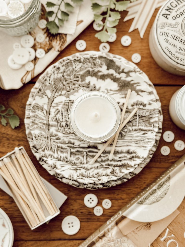 Cozy Eleanor Rose Home flatlay of favorite items like candles, vintage pieces, and books.