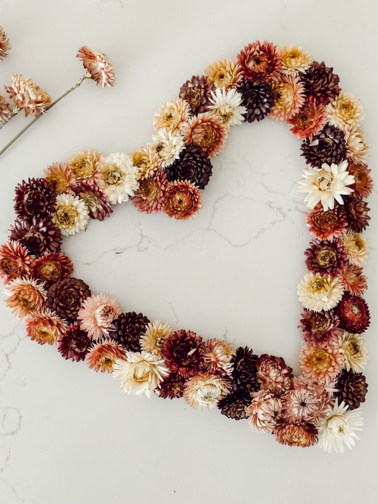 Easy DIY dried flower wreath in the shape of a heart for Valentine's Day decorations.