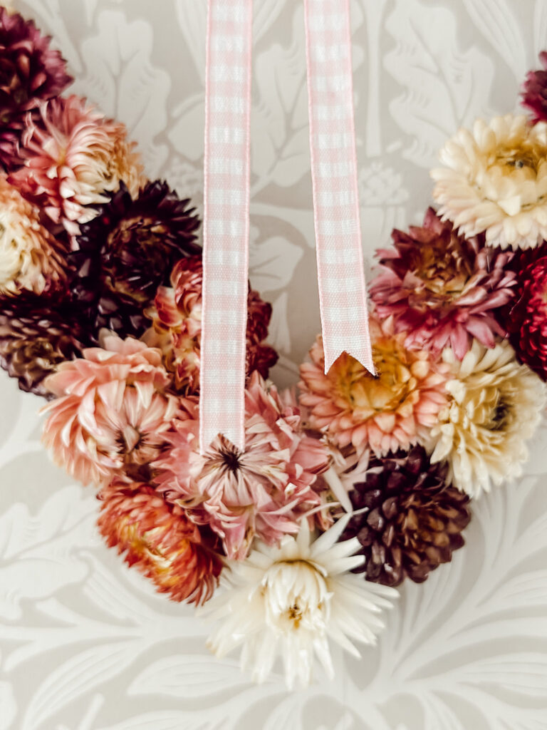 Easy dried flower heart wreath DIY made with straw flowers and wire wreath base for Valentine's Day.