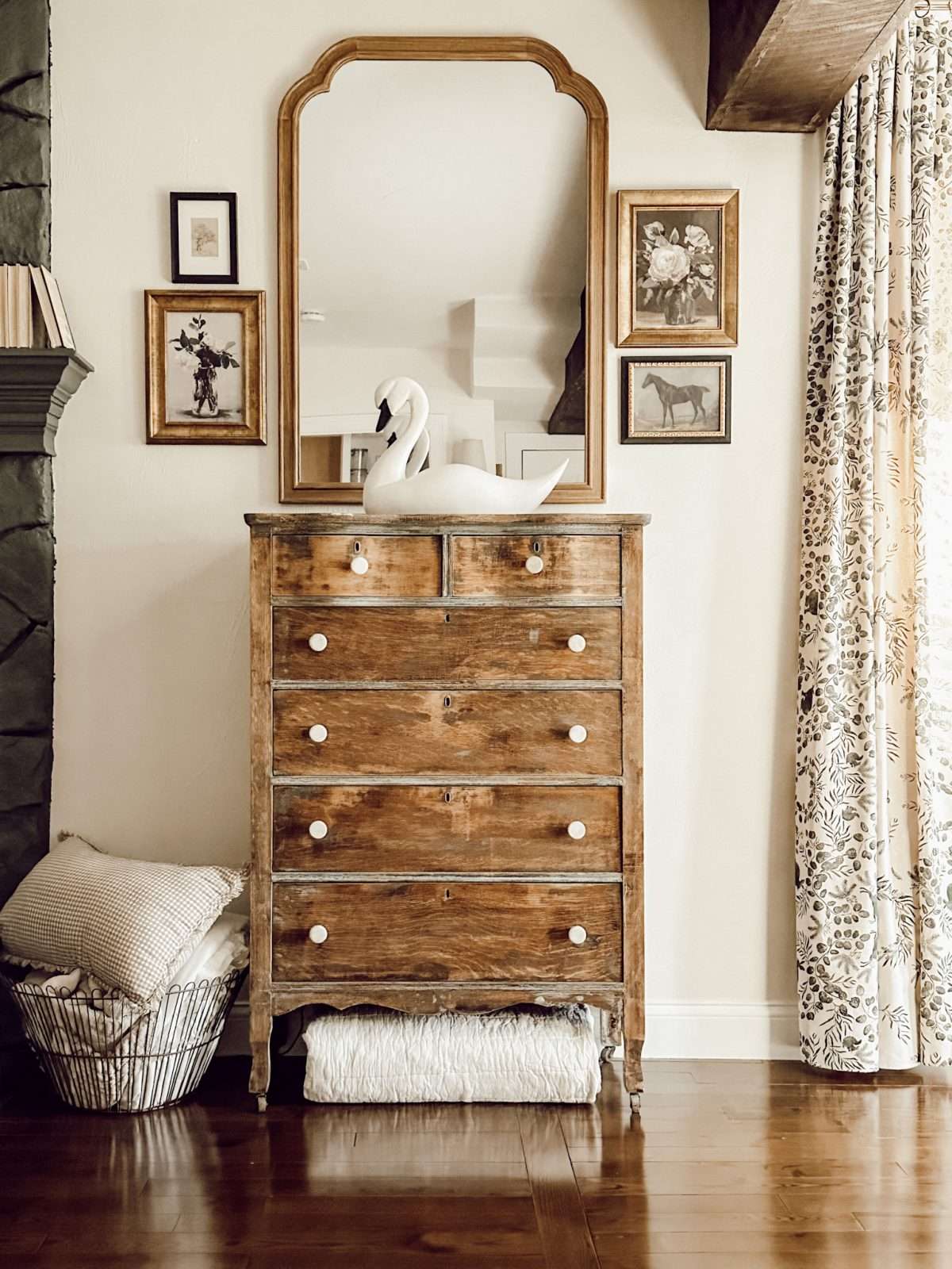 Natural color scheme in family room with wooden dresser and gallery wall.