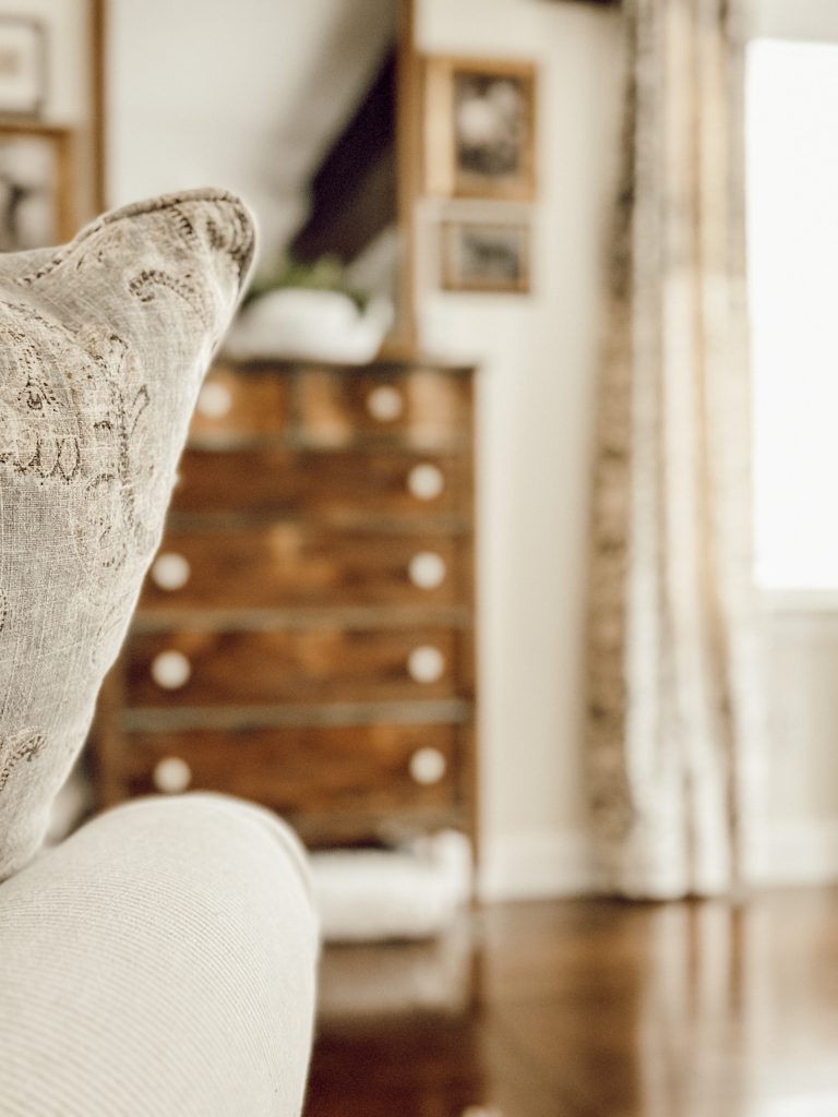 Tall armoire in the living room to add height to the room to make it feel bigger.