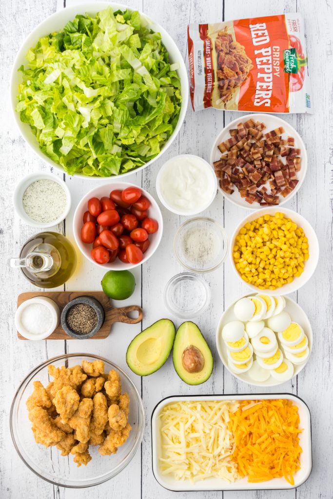Cobb salad simple ingredients include tender chicken, hard-boiled eggs, and crispy bacon.