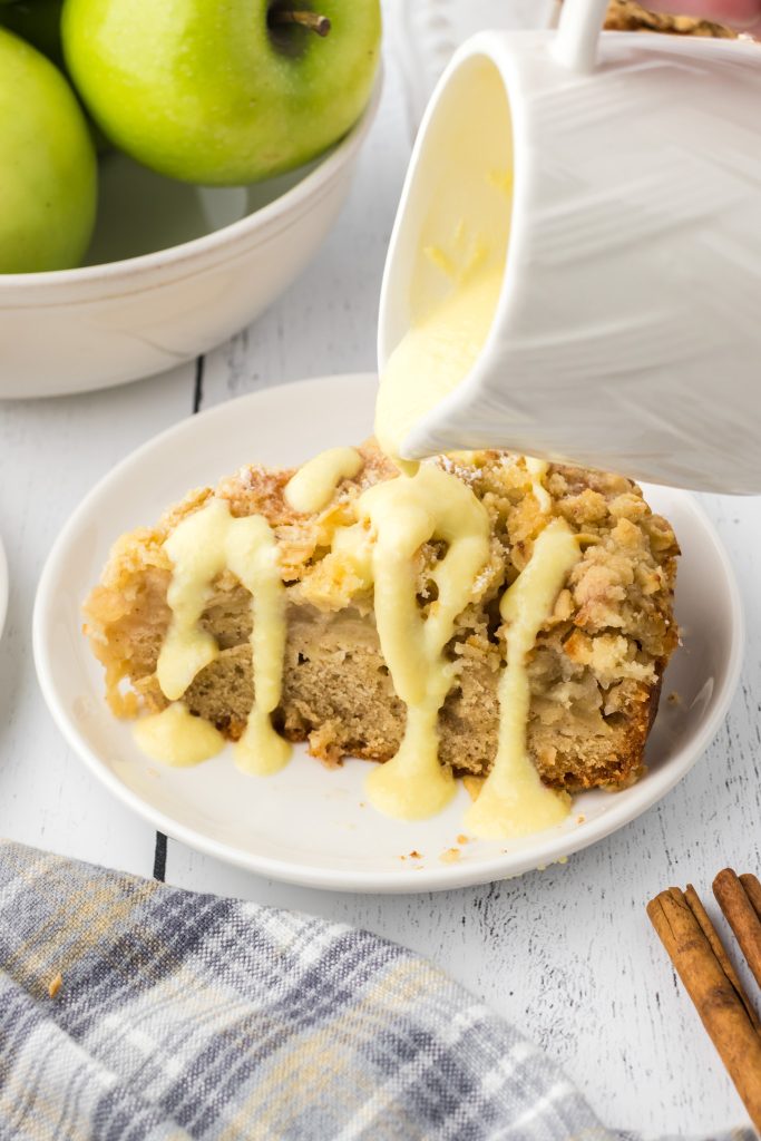 Kerry apple cake with a crumb topping drizzled with homemade custard sauce.