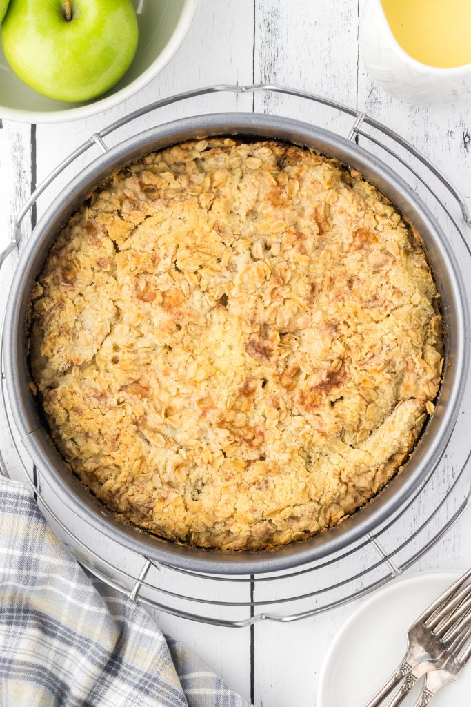 Irish apple cake cooling on wire rack before topping with custard sauce.