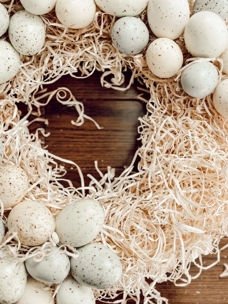 Plastic Easter eggs hot glued onto a straw wreath base.