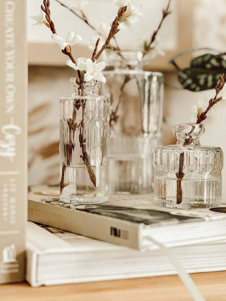 DIY floral arrangement with bud vases, faux flowers, and acrylic water.