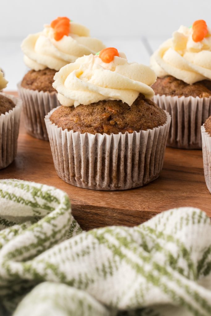A dozen delicious keto carrot cake cupcakes with rich creamy frosting.