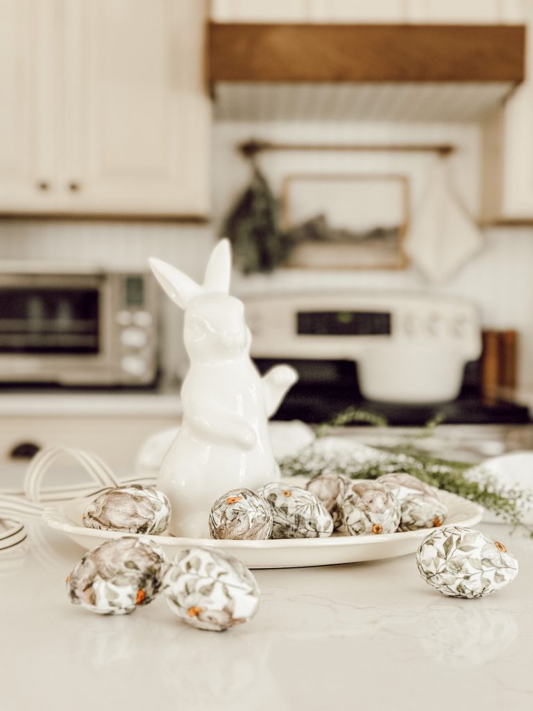 Spring decorations with DIY eggs on a ironstone platter on the kitchen counter.