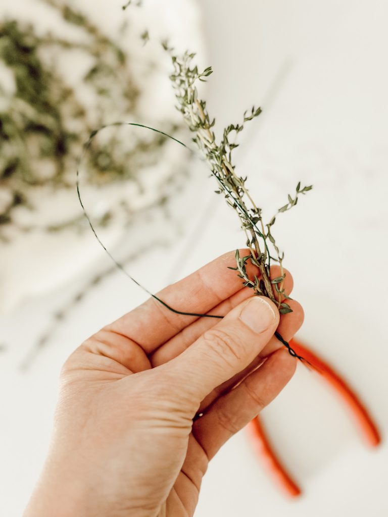 Fresh thyme wrapped onto floral wire to create a bunny ear cake topper for Easter celebrations.