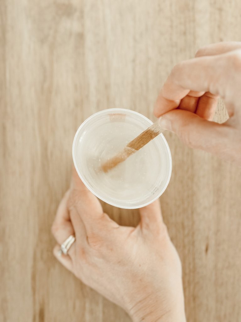 Mix the resin and hardener in a plastic cup to create fake water.