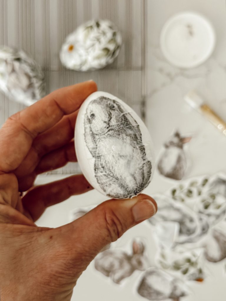 Cut out shapes from the paper napkin and glue them to the egg with Mod Podge.