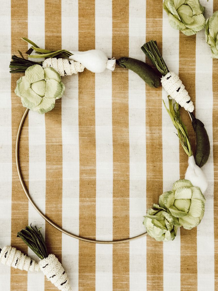 DIY felt seasonal wreath using a wire wreath form and felt vegetables.