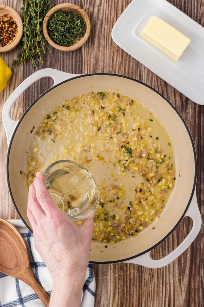 Use white wine to deglaze the large pot for the delicious creamy sauce.