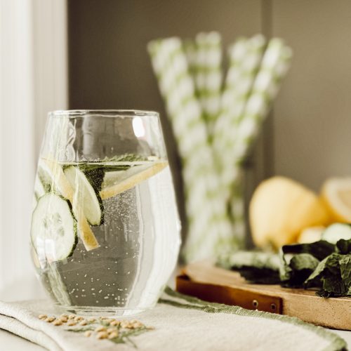 Fresh cucumber water with sliced cucumber, lemon slices, and fresh mint leaves.