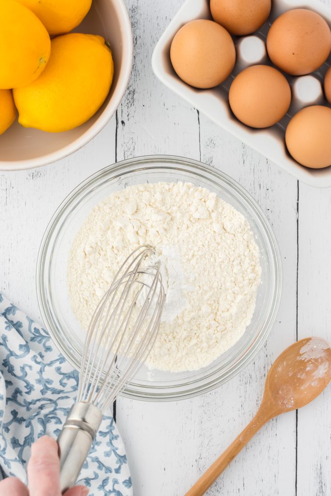 Whisk dry ingredients in a medium bowl for a delicious lemon cake.