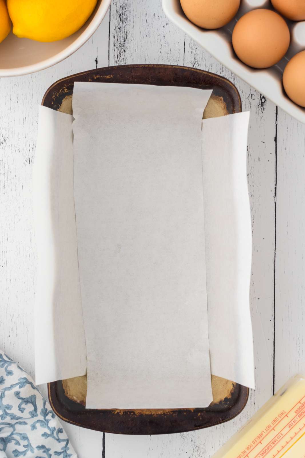 Bread pan lined with parchment paper to make a delicious pound cake.