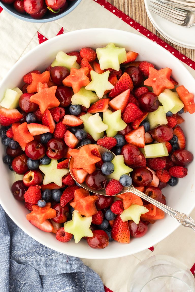 Patriotic fruit salad recipe with watermelon, strawberries, blueberries, and raspberries.