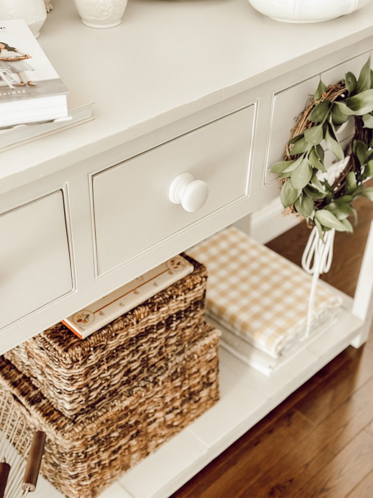 Display larger items like rattan baskets on the bottom shelf of your kitchen hutch. 