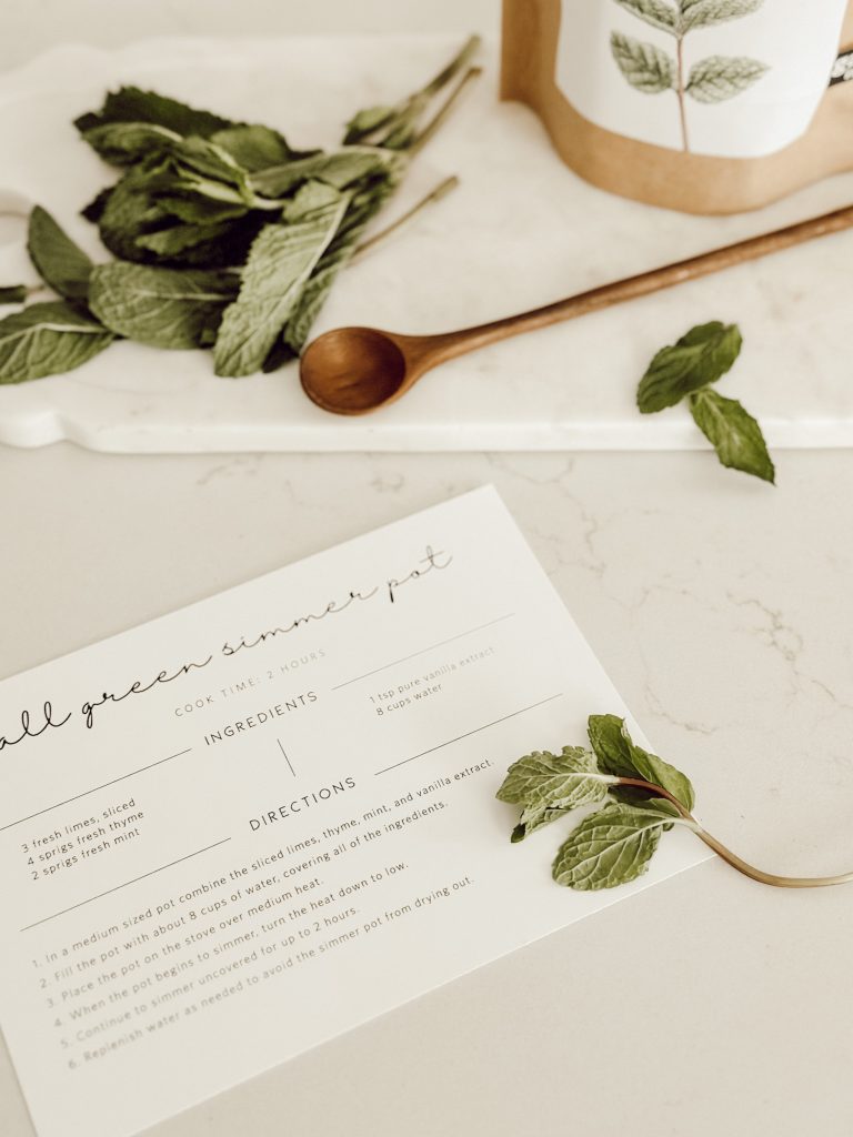 All green simmer pot recipe card with wooden spoon for easy stirring. 