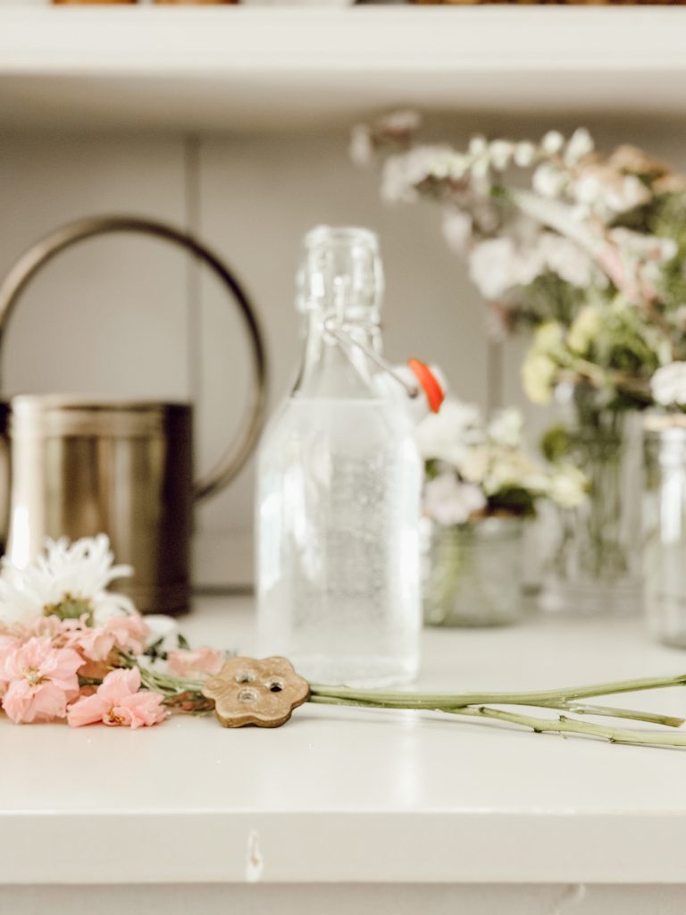 Arrange wildflowers in a glass vessel with the help of a DIY flower frog. 